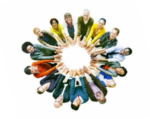 Diverse people standing in circle holding hands