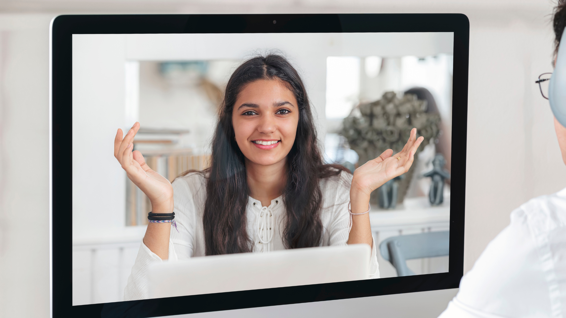 An image of a person video chatting a woman